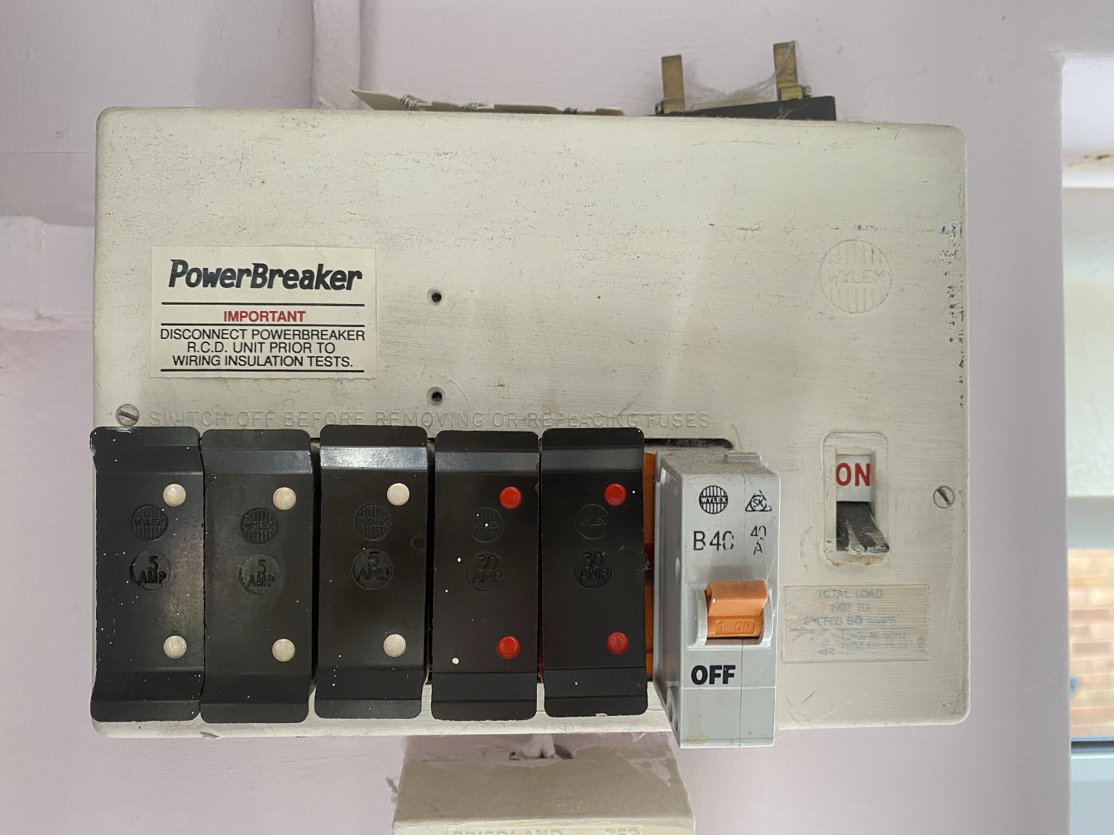 An old rewireable fuse board that should be replaced